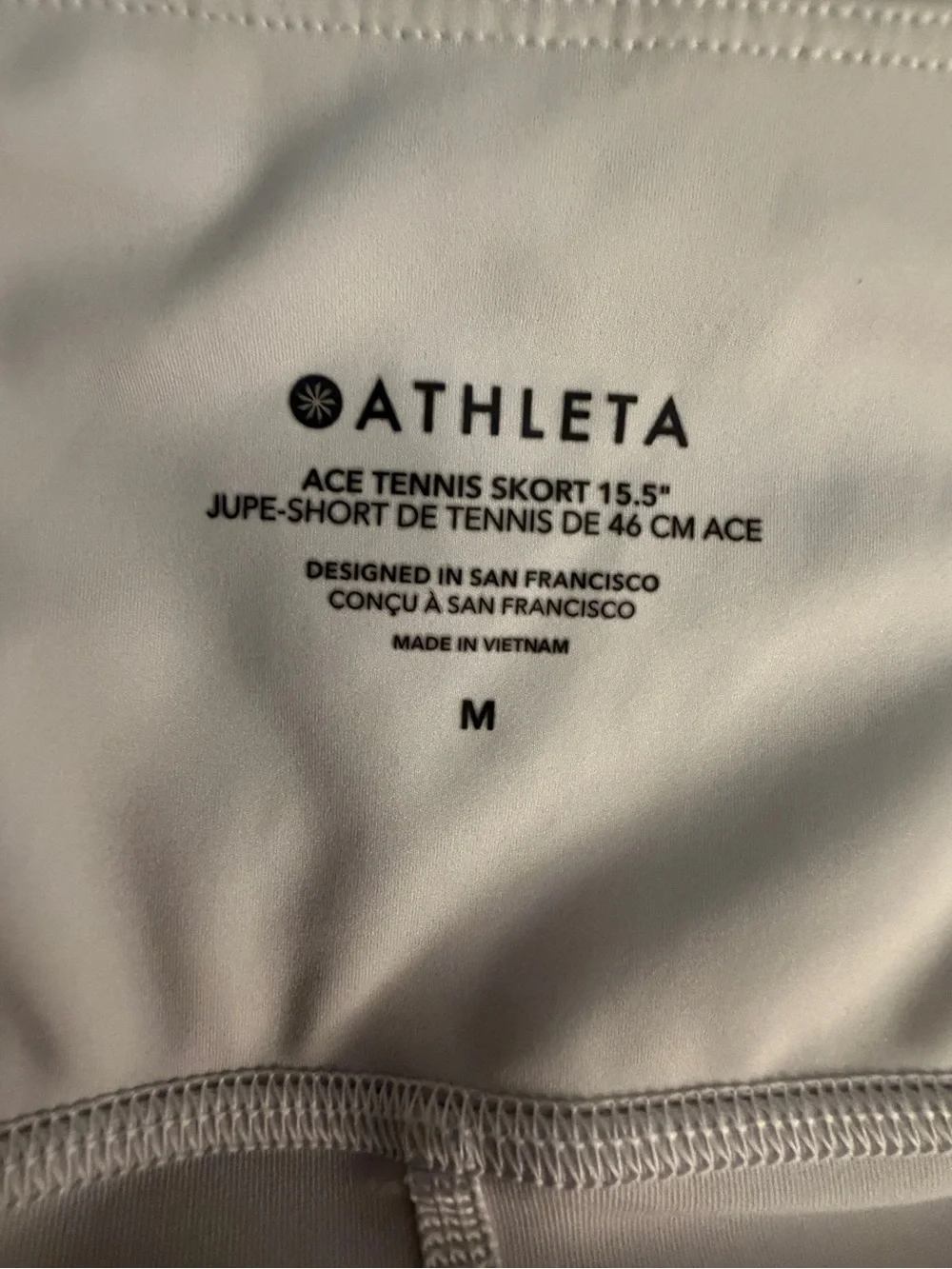 Athleta White Mini Skirt with Slight Flare, pockets on each side.